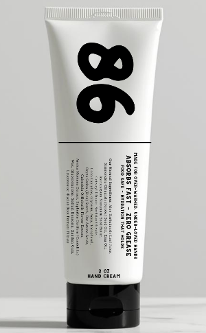 Hand cream tube labeled '86' on a gray background